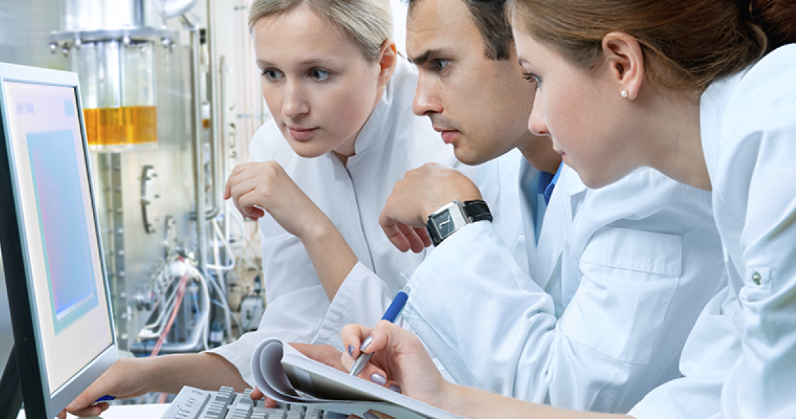 Scientists looking at a computer screen in a lab